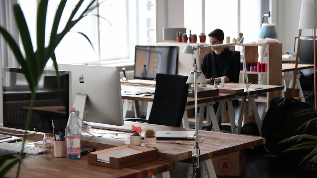 Open-plan office with modern decor and natural lighting, ideal for productivity.